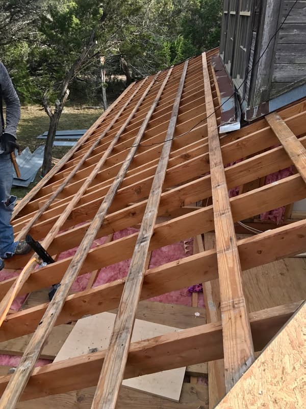 Roofing professionals working on a residential home